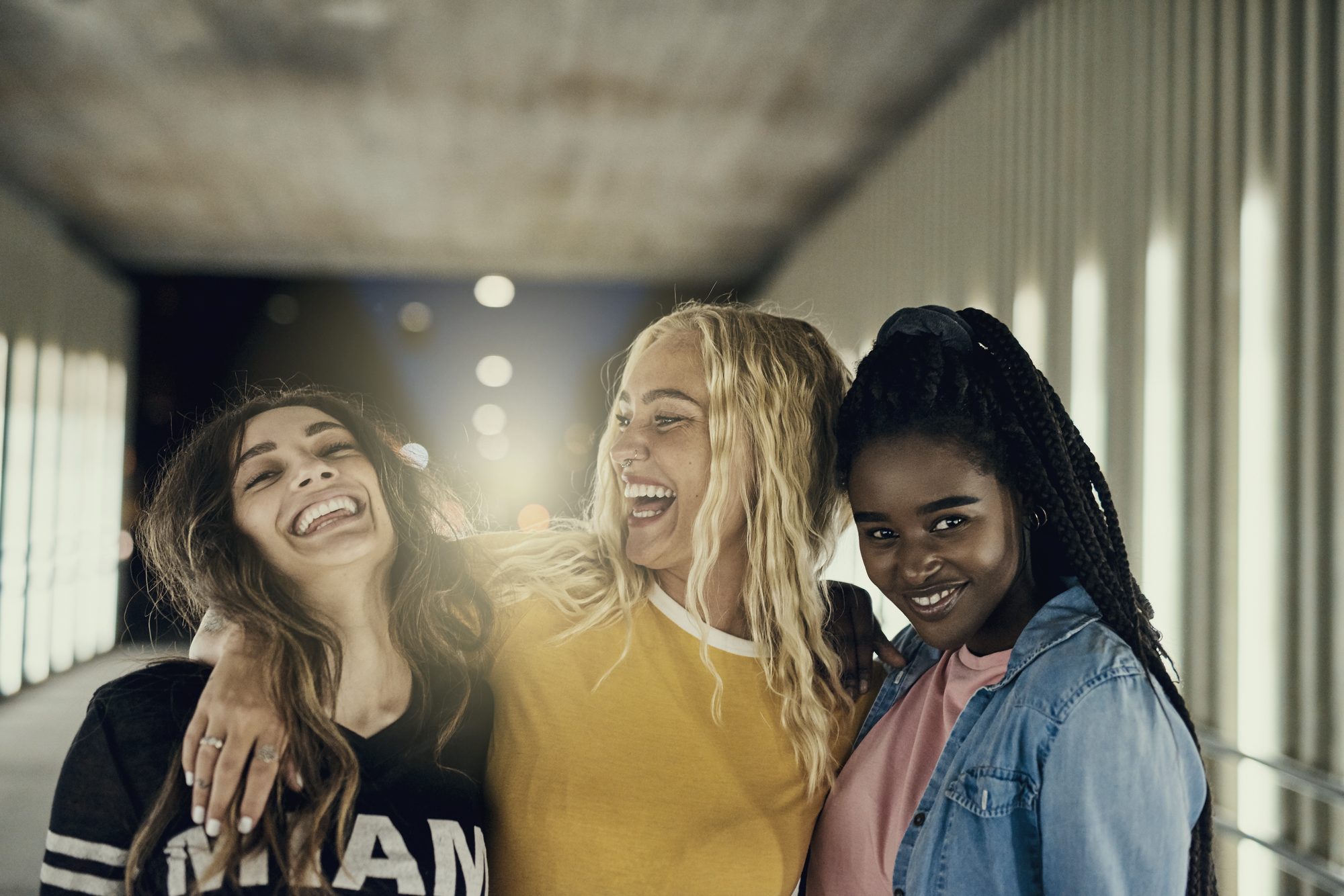Three friends in their twenties, smiling