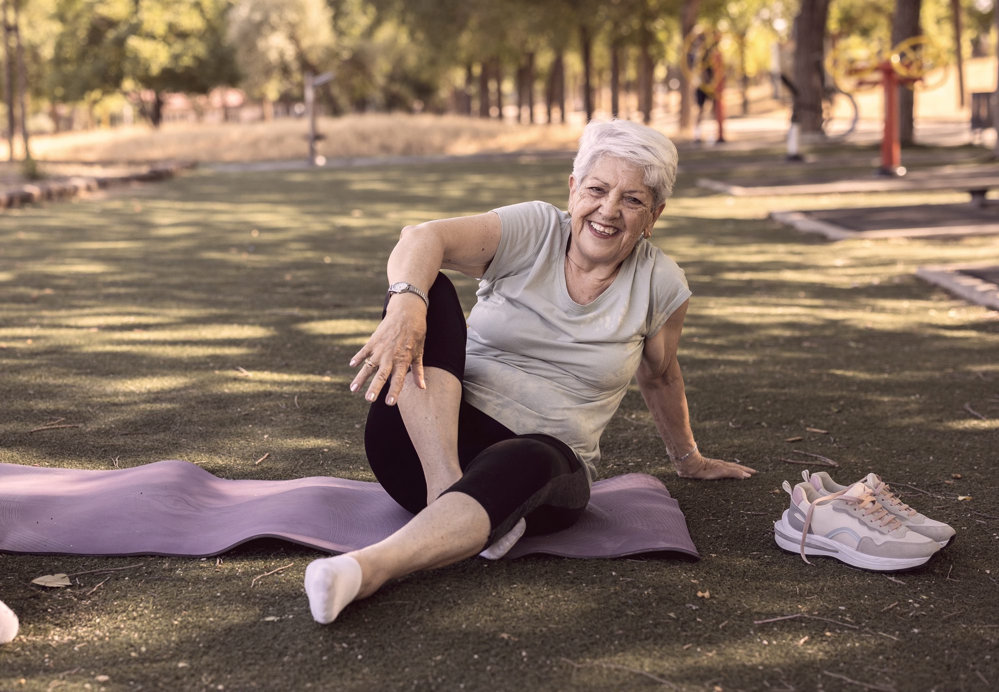A senior woman exercising in a park